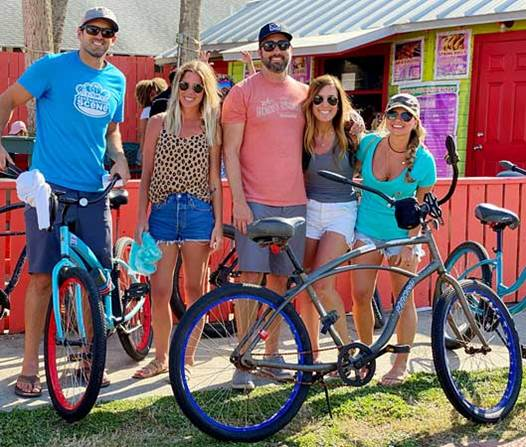 a group of people posing for a picture with their bikes